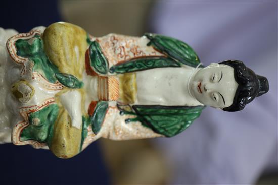 A Chinese Sancai glazed pottery seated figure of Guanyin, Qing dynasty, H.27cm, some flaking to glaze